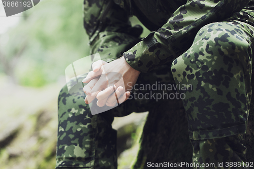 Image of close up of young soldier in military uniform