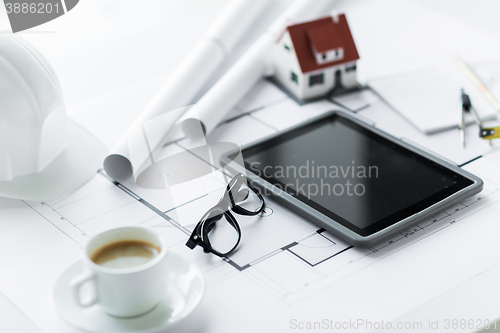 Image of close up of living house model and tablet pc