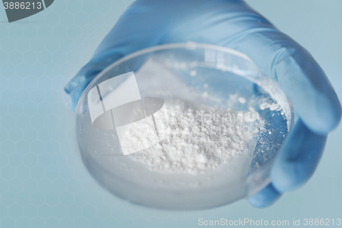 Image of close up of scientist hands holding petri dish