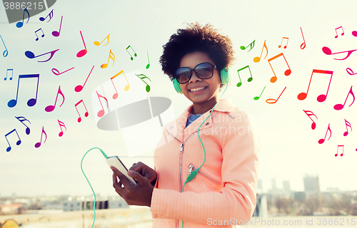 Image of happy young woman with smartphone and headphones