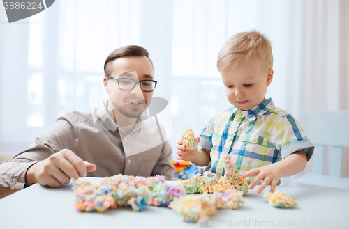 Image of father and son playing with ball clay at home