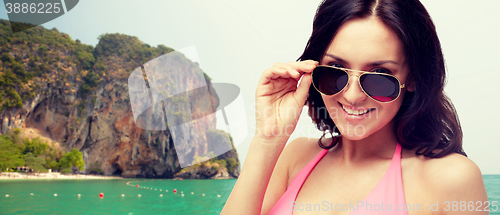 Image of happy woman in sunglasses and swimsuit
