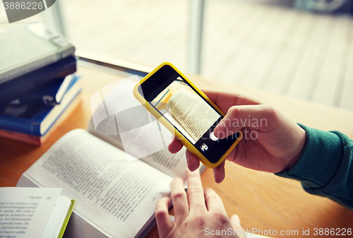 Image of student hands with smartphone making cheat sheet