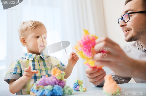 Image of father and son playing with ball clay at home