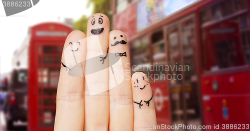 Image of close up of four fingers with smiley faces