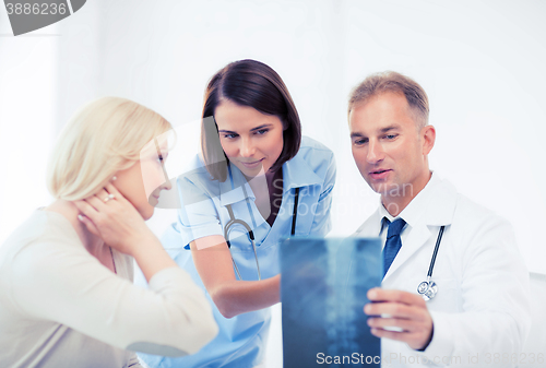 Image of doctors with patient looking at x-ray