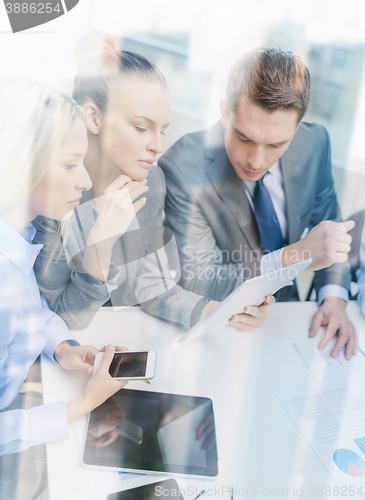 Image of business team with tablet pc having discussion