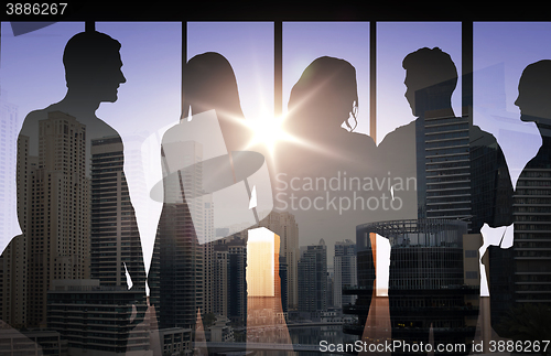 Image of people silhouettes over city background