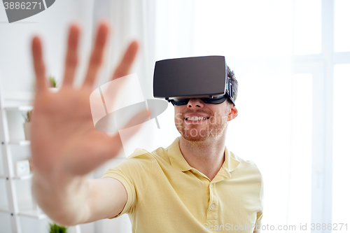 Image of young man in virtual reality headset or 3d glasses