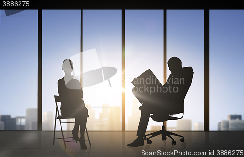 Image of silhouette of business people working at office