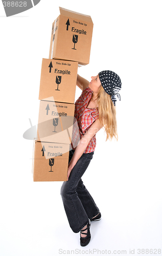 Image of Woman with cardboard boxes ready to fall