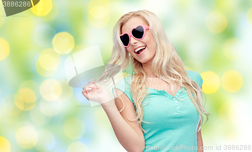 Image of happy young blonde woman or teenager in sunglasses