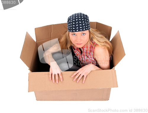 Image of Cute girl sitting in a cardboard box