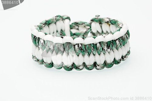 Image of green braided bracelet on white background