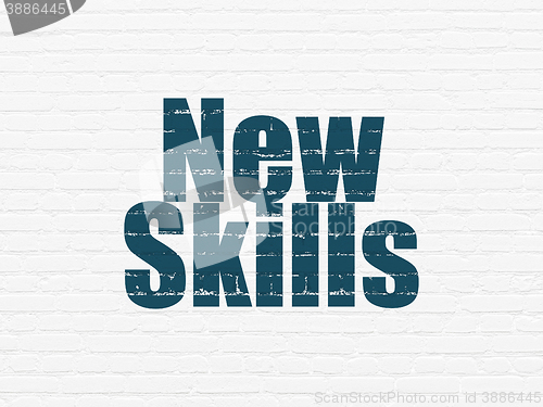 Image of Education concept: New Skills on wall background