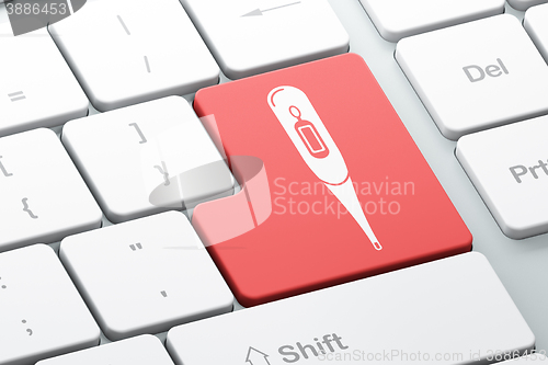 Image of Health concept: Thermometer on computer keyboard background