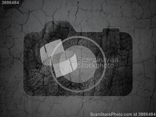 Image of Vacation concept: Photo Camera on grunge wall background