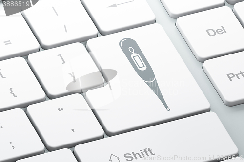 Image of Healthcare concept: Thermometer on computer keyboard background