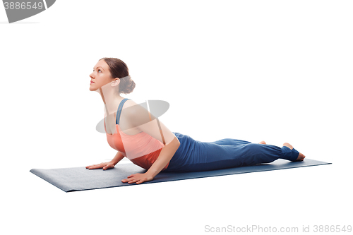 Image of Sporty fit yogini woman practices yoga asana bhujangasana 