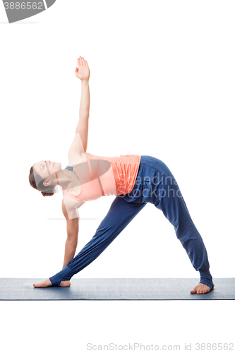 Image of Woman practices yoga asana utthita trikonasana