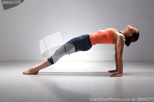 Image of Sporty fit yogini woman practices Ashtanga Vinyasa