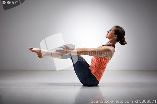 Image of Sporty fit woman practices Ashtanga Vinyasa yoga