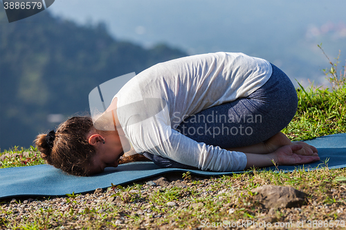 Image of Sporty fit woman practices yoga asana Balasana