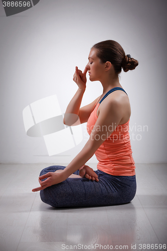 Image of Sporty fit yogini woman practices yoga pranayama breath control 