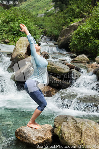 Image of Sorty fit woman doing yoga asana Utkatasana 