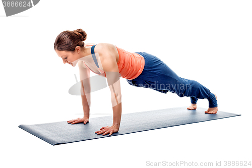 Image of Young fit sporty woman does Hatha yoga plank asana