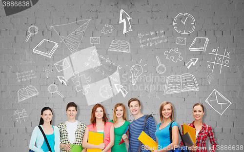 Image of group of teenage students with folders and bags