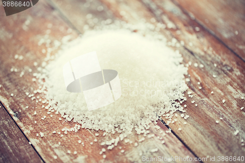 Image of close up of white salt heap on wooden table