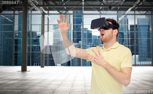 Image of happy man in virtual reality headset or 3d glasses