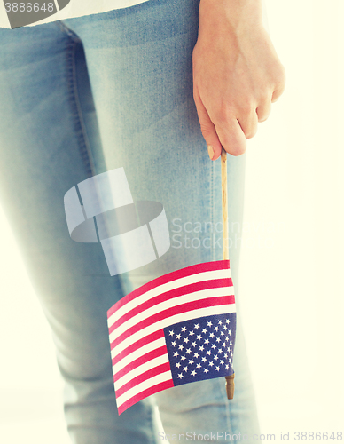 Image of close up of woman holding american flag in hand