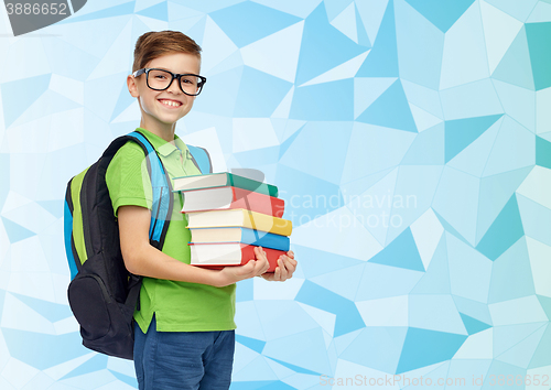 Image of happy student boy with school bag and books