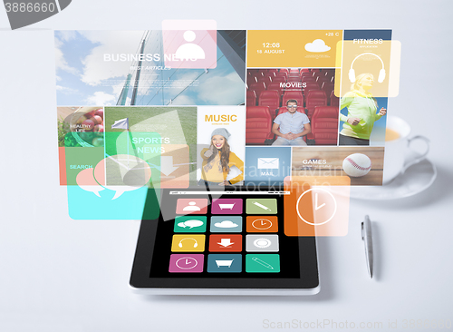 Image of tablet pc with application icons and cup of coffee