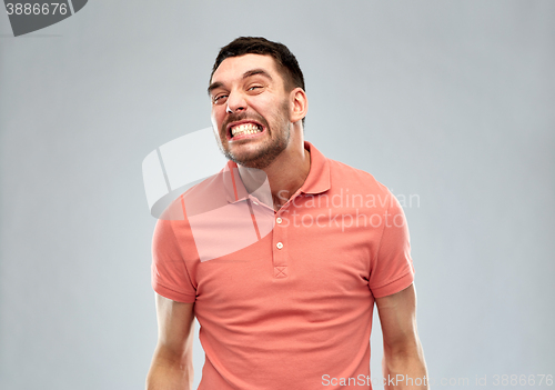 Image of angry man over gray background