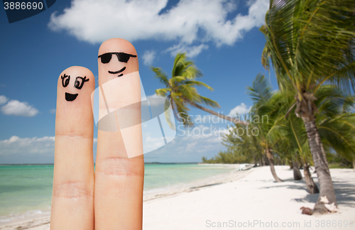 Image of close up of two fingers with smiley faces