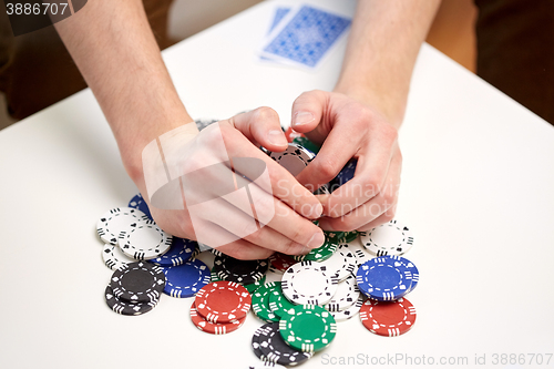 Image of hands with casino chips making bet or taking win