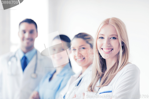 Image of female doctor in front of medical group