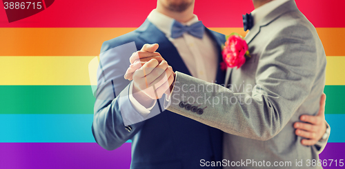 Image of close up of happy male gay couple dancing