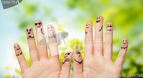 Image of close up of hands and fingers with smiley faces