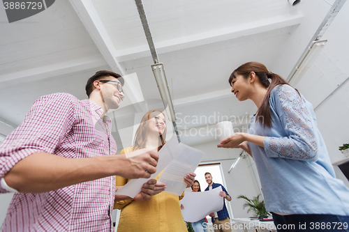 Image of creative team on coffee break talking at office