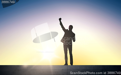 Image of silhouette of business man with over sun light