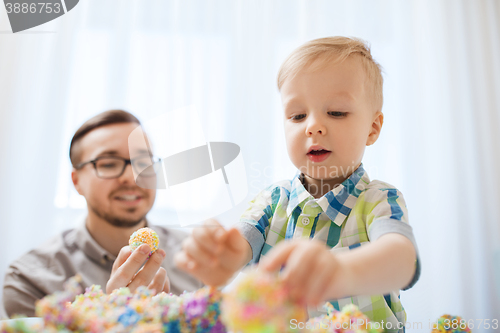 Image of father and son playing with ball clay at home