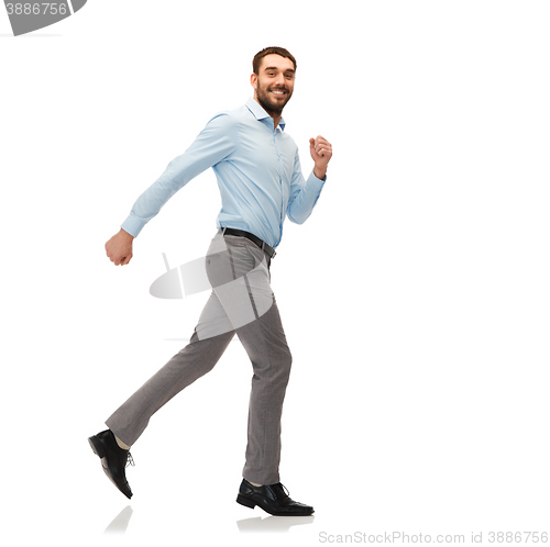 Image of smiling young man running away