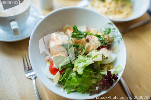 Image of close up of caesar salad on plate at restaurant