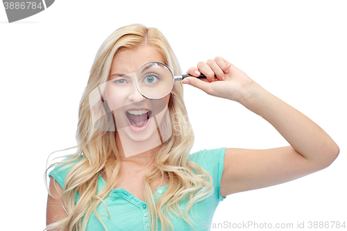 Image of happy young woman with magnifying glass