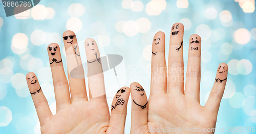 Image of close up of hands and fingers with smiley faces