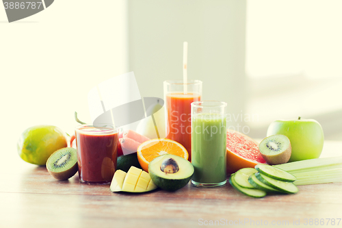 Image of close up of fresh juice glass and fruits on table